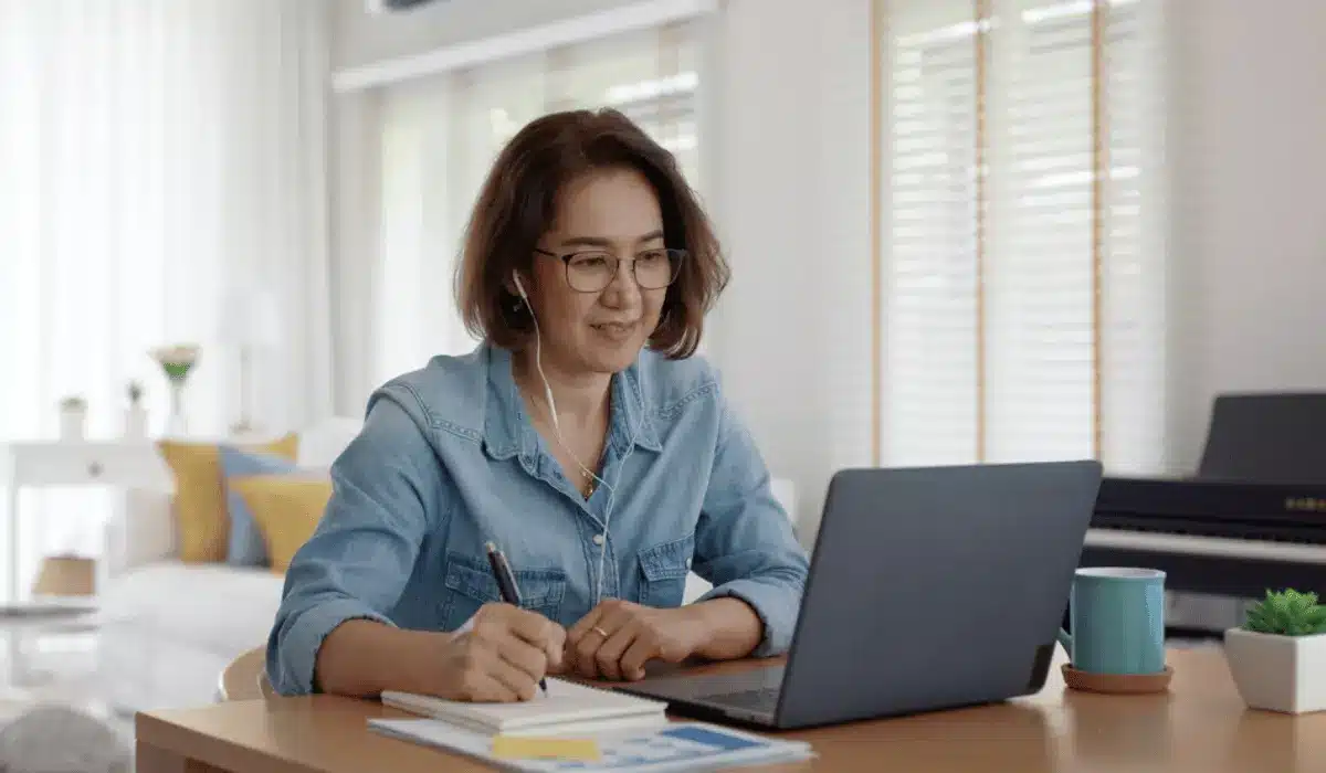 eLearning Content Multimedia Development Malaysian employee smiling at camera while working on simple to use eLearning software